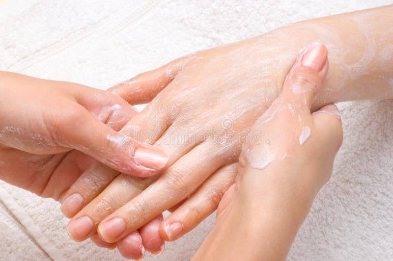 Applying peeling scrub or moisturizing cream onto the hands. Applying peeling scrub or moisturizing cream onto the hands