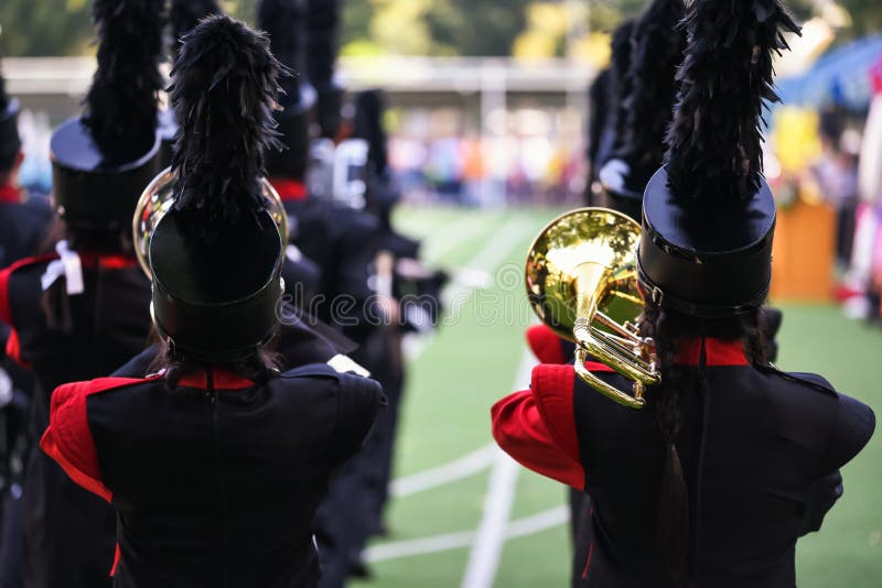 Rear school marching band with horn music instrument. Parade of Musician teamwork concept, action, blur, brass, celebration, children, city, copy, entertainment, festival, gloves, gold, military, musical, people, perform, performance, performer, person, play, precision, red, sound, space, sport, street, synergy, teenager, trombone, trombonist, uniform, unison, vertical, walk. Rear school marching band with horn music instrument. Parade of Musician teamwork concept, action, blur, brass, celebration, children, city, copy, entertainment, festival, gloves, gold, military, musical, people, perform, performance, performer, person, play, precision, red, sound, space, sport, street, synergy, teenager, trombone, trombonist, uniform, unison, vertical, walk