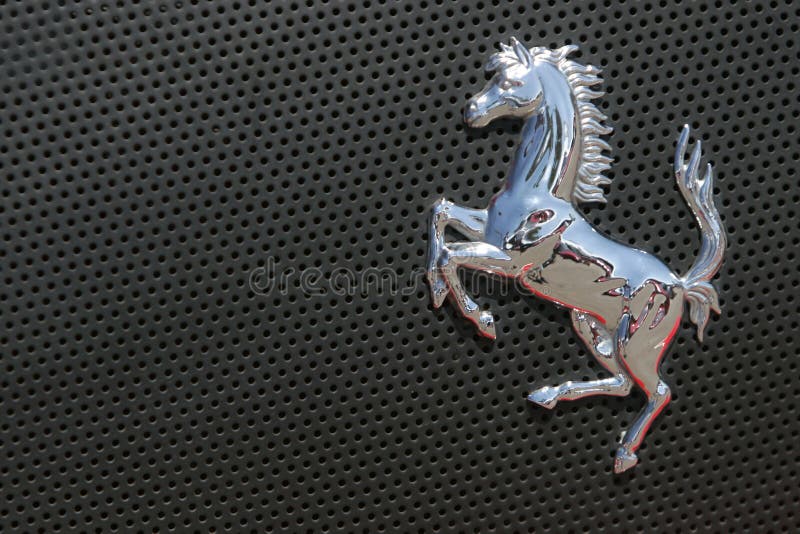 Ferrari logo on gray sport car, Cavallino Rampante badge. Ferrari logo on gray sport car, Cavallino Rampante badge
