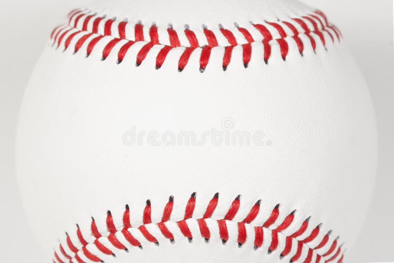 The top and bottom red stitching of a baseball framing area for copy on white leather baseball surface. The top and bottom red stitching of a baseball framing area for copy on white leather baseball surface