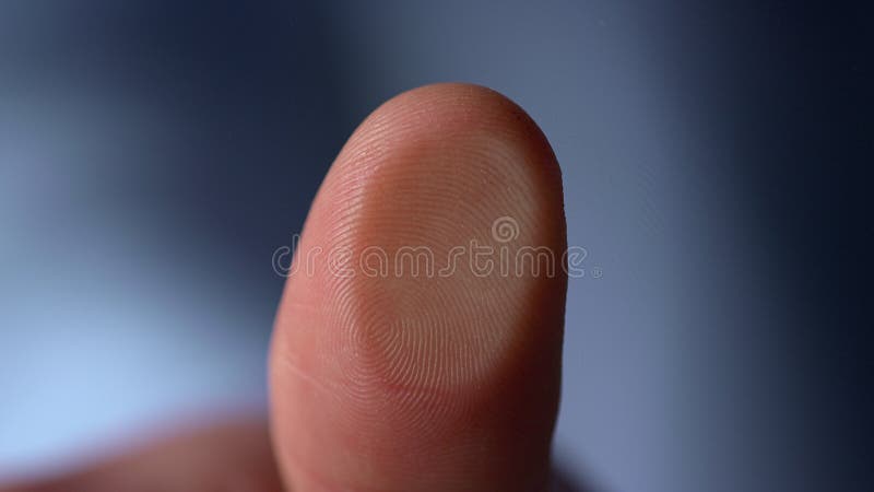 Marco video of fingerprint on glass surface indoors. Male finger pressing glassware on blue background. Man thumbprint on windowpane inside. Person making fingerprinting. Fingerprint macro stock images, royalty-free photos and pictures