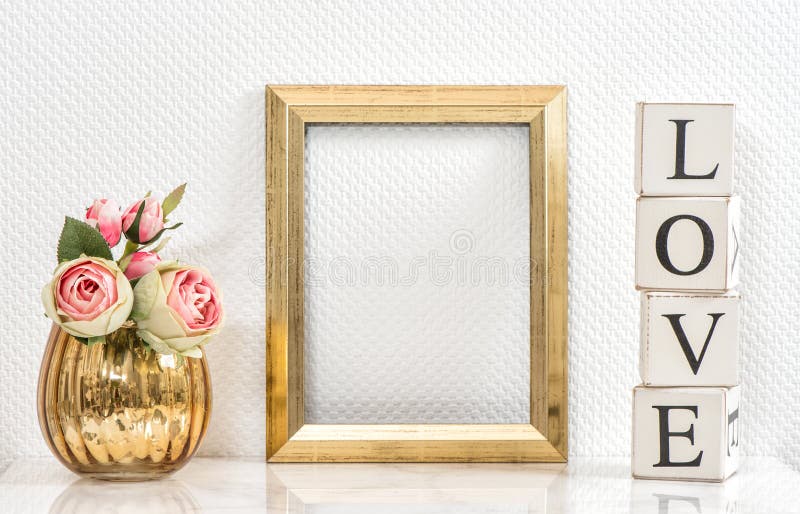 Picture frame and pink roses. Valentines Day concept. Mock up with golden frame and flowers with space for your picture or text. Picture frame and pink roses. Valentines Day concept. Mock up with golden frame and flowers with space for your picture or text