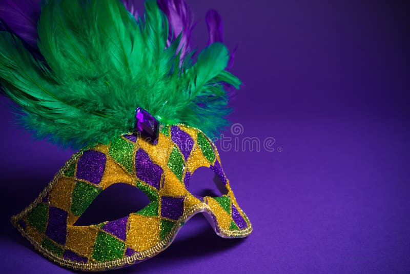 Mardi Gras or Carnivale mask on a purple background stock image