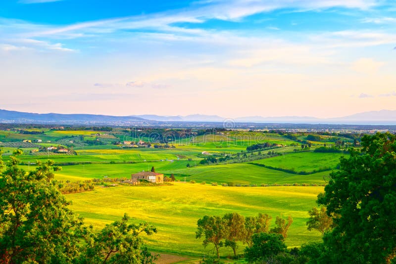 Maremma, rural sunset landscape. Countryside farm and green fields. Elba island on horizon. Tuscany, Italy, Europe. Maremma, rural sunset landscape. Countryside farm and green fields. Elba island on horizon. Tuscany, Italy, Europe.