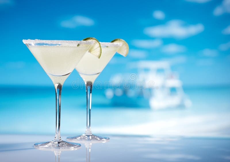 Margarita cocktail on beach, blue sea and sky background