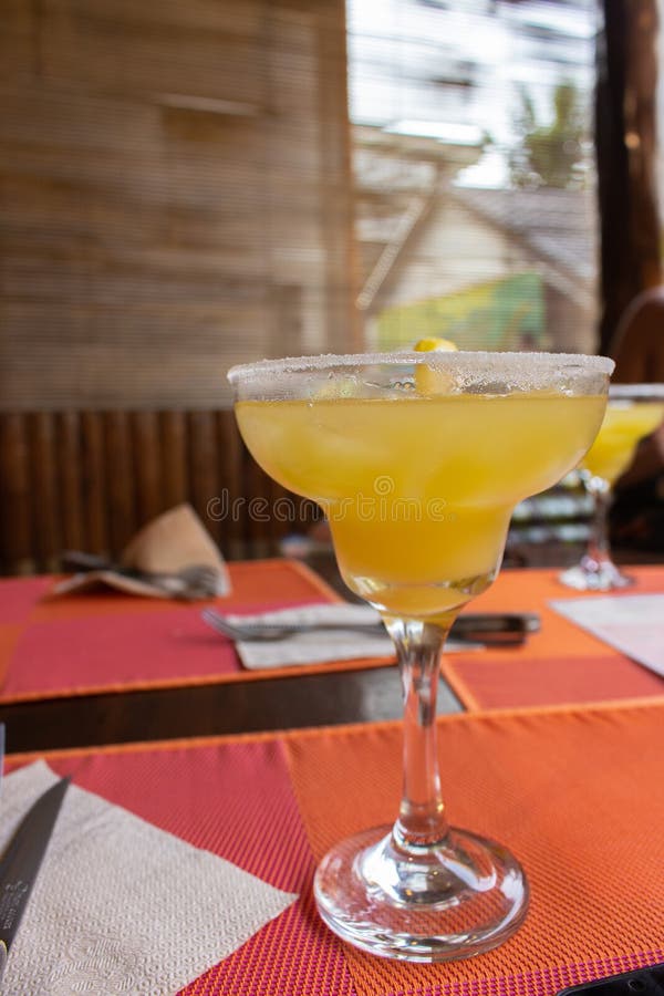 Margarita cocktail with ice cubes and lemon slice and salt. Cold cocktail in martini glass. Alcoholic drinks concept. stock image Margarita cocktail with ice cubes and lemon slice and salt. Cold cocktail in martini glass. Alcoholic drinks concept. stock image