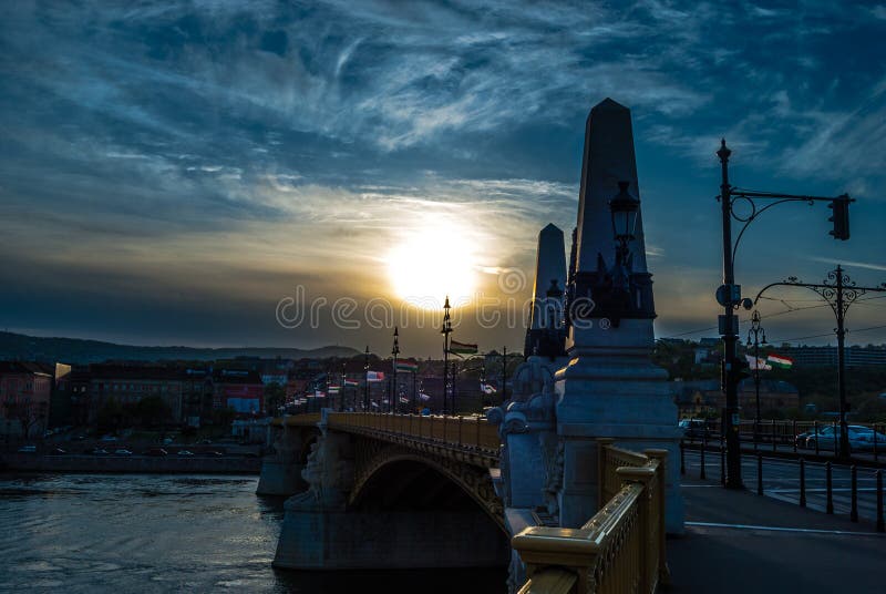 Margit or Margaret Bridge in Budapest, Hungary. It connects Buda and Pest across the Danube. Against spectacular sunset. Margit or Margaret Bridge in Budapest, Hungary. It connects Buda and Pest across the Danube. Against spectacular sunset.