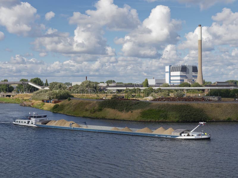 The Maria B, a Dutch river Barge with its Cargo of sand and stone chippings proceeding up the North Sea Canal to the Port of Amsterdam. The Maria B, a Dutch river Barge with its Cargo of sand and stone chippings proceeding up the North Sea Canal to the Port of Amsterdam