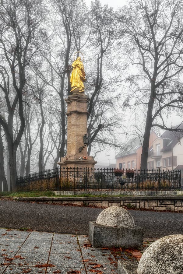 Marian column Immaculata in foggy park in city Ruzomberok, Slovakia