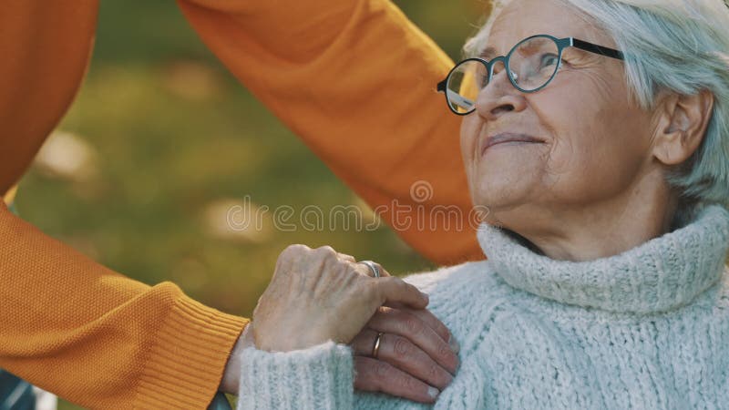 Marido amoroso que cuida a su esposa discapacitada en la naturaleza.