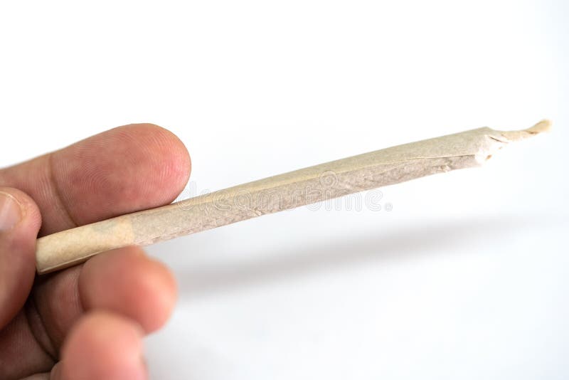 Marijuana cannabis joint in hand fotografering för bildbyråer Marijuana cannabis joint in hand fotografering för bildbyråer