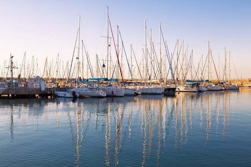 Marina with docked yachts at sunset stock photo Marina with docked yachts at sunset stock photo