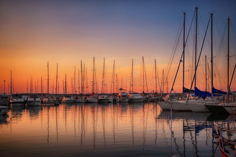 Marina with docked yachts at sunset