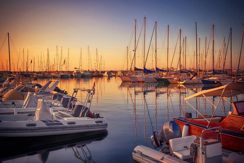 Marina with docked yachts at sunset