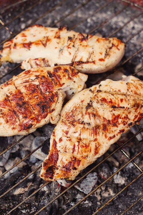 Marinated chicken steaks on a grill