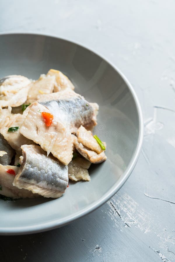 Marinated Fish Fillet with Vegetables and Spices on the Rustic