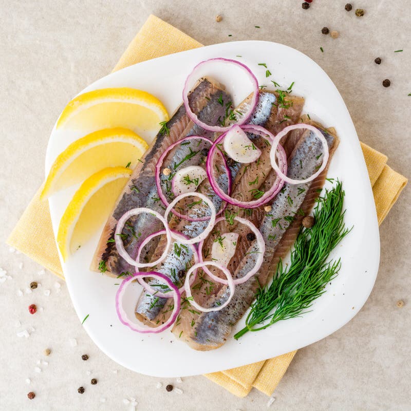 Marinated Herring Fillets with Red Onion, Dill and Spices on White