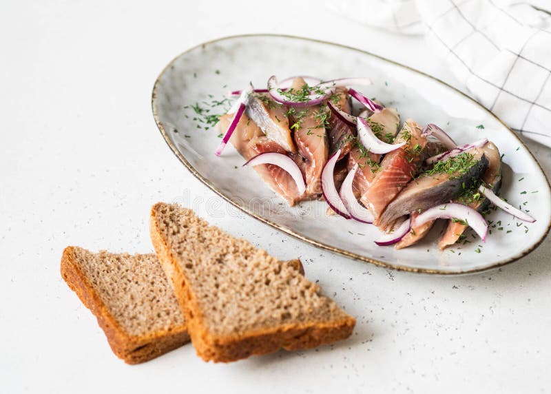 Marinated Herring Fish Slices with Fresh Dill and Red Onion, Rye Bread