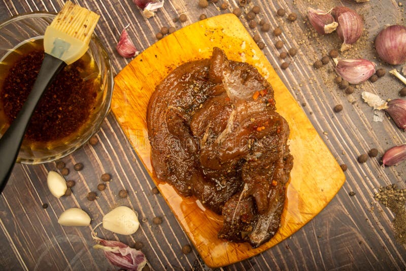 Marinated Meat on a Cutting Board, Garlic, Allspice, Spices. Close Up