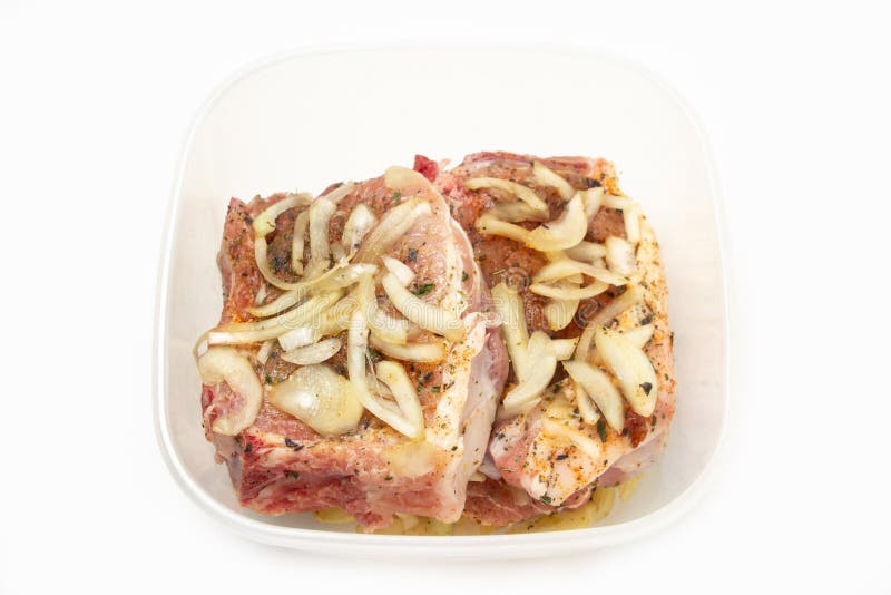 Marinated Meat in a Plastic Container on a White Background. Stock