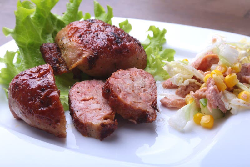 Marinated roaste chicken breasts cooked on BBQ and served with fresh salad on white plate, close-up. royalty free stock photo Marinated roaste chicken breasts cooked on BBQ and served with fresh salad on white plate, close-up. royalty free stock photo