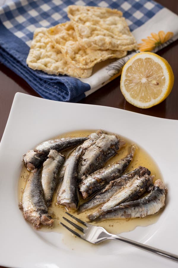 Marinated Sardines in the Oil Served with Lemon and Corn Bread Stock