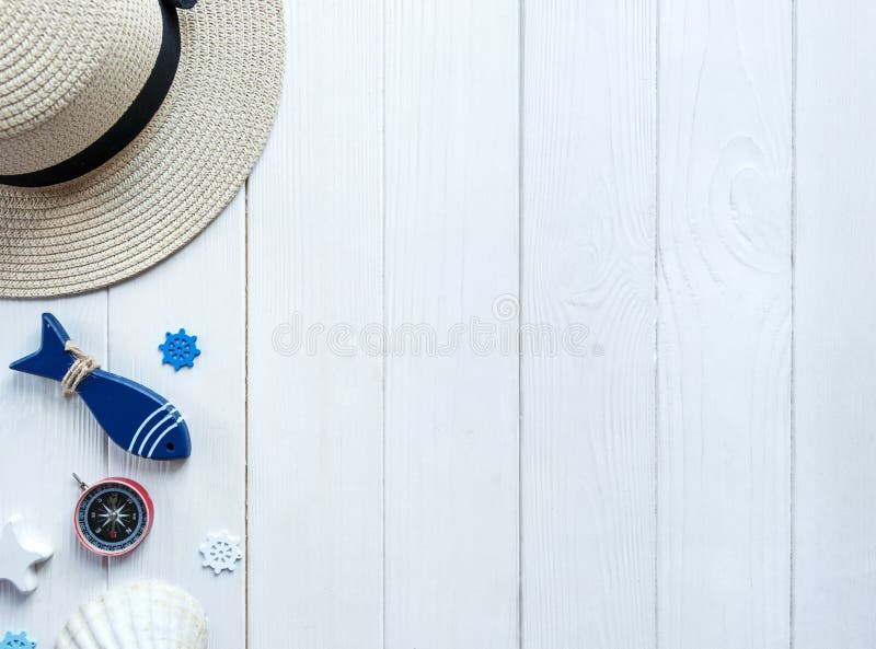 Marine items on wooden background. Sea objects: straw hat, swimsuit, fish, shells . flat lay, copy space. vacation and travel