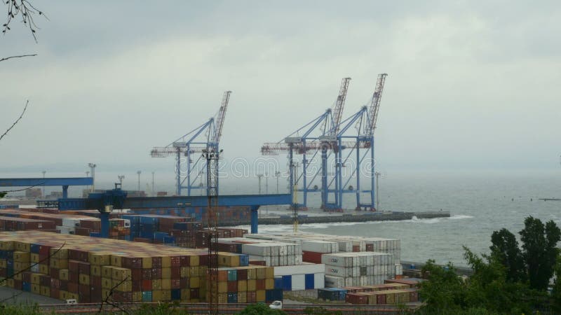 Marine port cranes, container terminal and industrial zone in cargo front of Odessa sea commercial port in Ukraine.