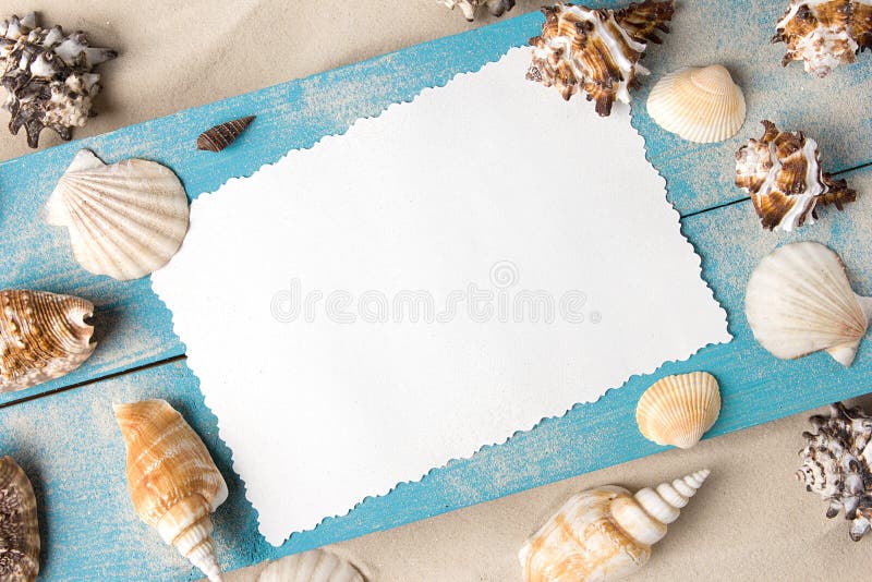 Marine summer postcard. Seashells on blue wooden boards in the sand on the beach stock photo Marine summer postcard. Seashells on blue wooden boards in the sand on the beach stock photo