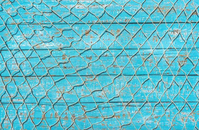 Fishing net texture on rustic blue wooden background with copy space. Fishing net texture on rustic blue wooden background with copy space