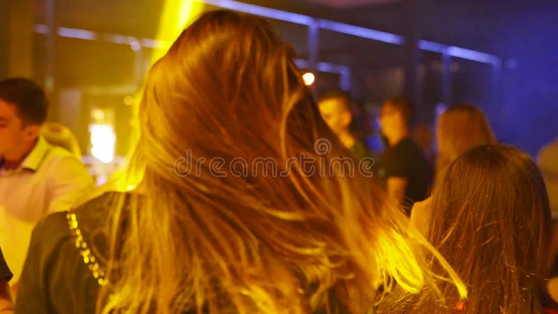 Mariupol, Ukraine - 15 June 2019. People are dancing in Barbaris night club lit by show lights. Silhouettes of men and