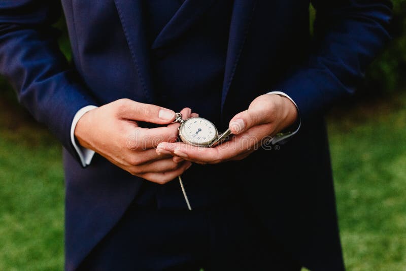 Groom with old pocket watch. Groom with old pocket watch.