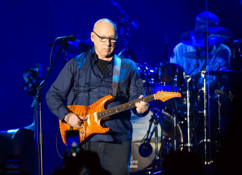 BARCELONA, SPAIN - APRIL 26, 2019: Mark Knopfler performing live on stage of famous Palau Sant Jordi. BARCELONA, SPAIN - APRIL 26, 2019: Mark Knopfler performing live on stage of famous Palau Sant Jordi