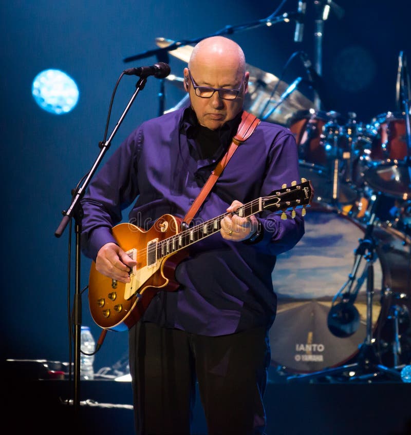 BARCELONA, SPAIN - APRIL 26, 2019: Mark Knopfler performing live on stage of famous Palau Sant Jordi. BARCELONA, SPAIN - APRIL 26, 2019: Mark Knopfler performing live on stage of famous Palau Sant Jordi