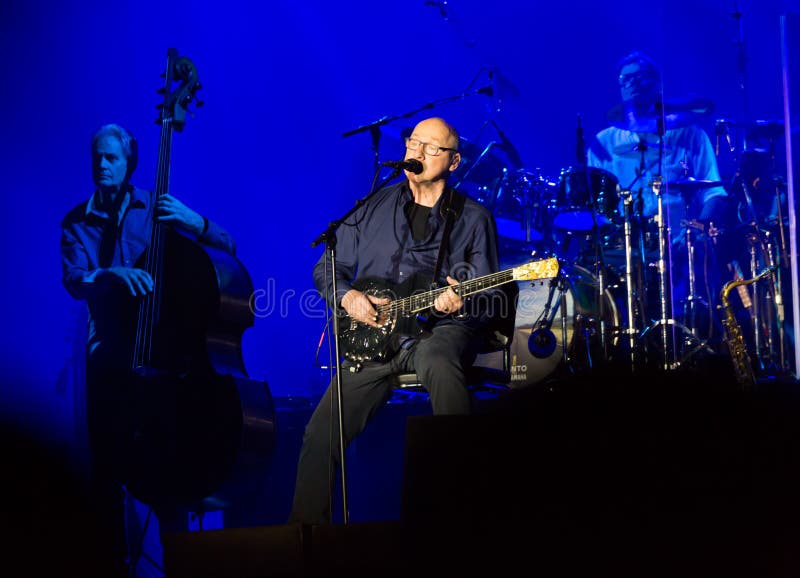 BARCELONA, SPAIN - APRIL 26, 2019: Mark Knopfler performing live on stage of famous Palau Sant Jordi. BARCELONA, SPAIN - APRIL 26, 2019: Mark Knopfler performing live on stage of famous Palau Sant Jordi