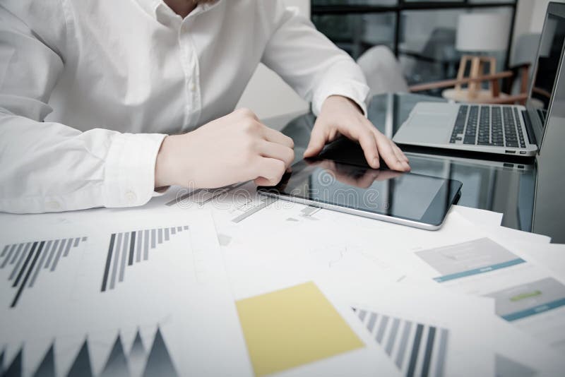 Marketing Time Management. Work process.Photo Trader working Market Report Documents Touching Tablet,Reflections Screen royalty free stock images Marketing Time Management. Work process.Photo Trader working Market Report Documents Touching Tablet,Reflections Screen royalty free stock images