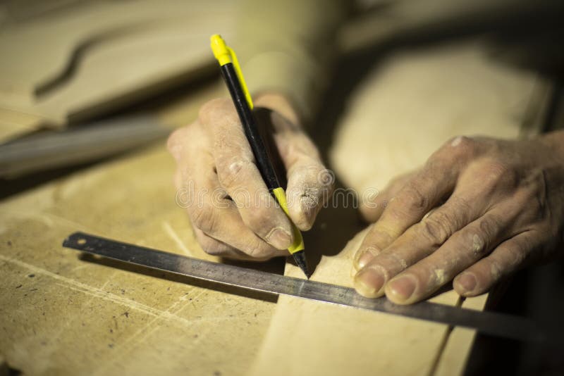 Marking on Ruler with Pencil. Drawing Line on Tree. Hands of Carpenter
