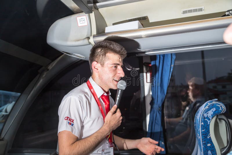 Marmaris, Turkey - May 19, 2018: Male tour guide with a microphone in the bus stock images Marmaris, Turkey - May 19, 2018: Male tour guide with a microphone in the bus stock images