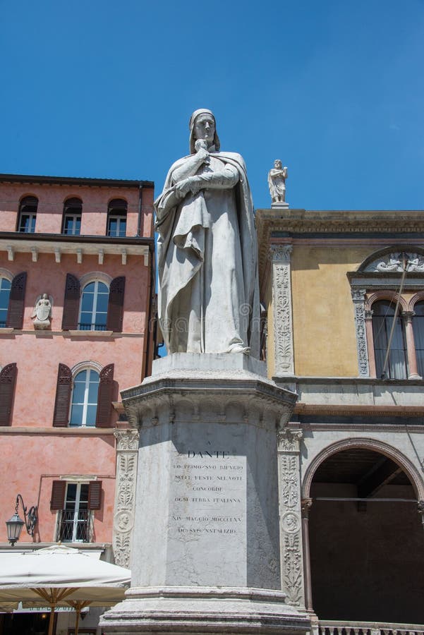 Dante Alighieri marble monument in the center of the city Verona, northern Italy. A civilian part of the town with trees and benches, blue sky. Dante Alighieri marble monument in the center of the city Verona, northern Italy. A civilian part of the town with trees and benches, blue sky.
