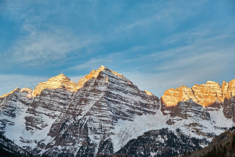 Maroon Bells mountains in snow at sunrise stock photo Maroon Bells mountains in snow at sunrise stock photo