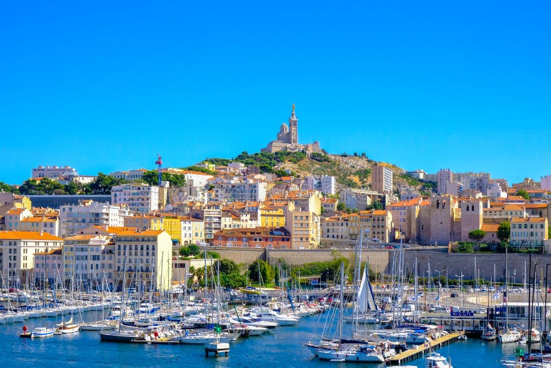 Marseille embankment with yachts and boats in the Old Port and Notre Dame de la Garde. Vieux-Port de Marseille