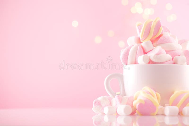 Marshmallow. Close-up of Marshmallows colorful chewy candy, over pink bokeh background, closeup. Sweet holiday food dessert