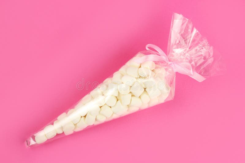 Marshmallow in a Gift Plastic Bag on a Pink Background Stock Photo