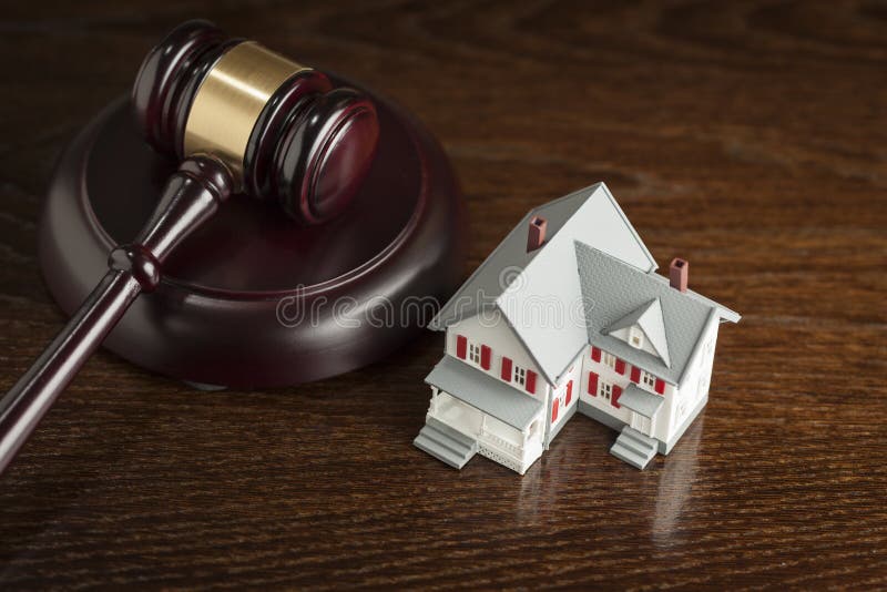 Gavel and Small Model House on Wooden Table. Gavel and Small Model House on Wooden Table.