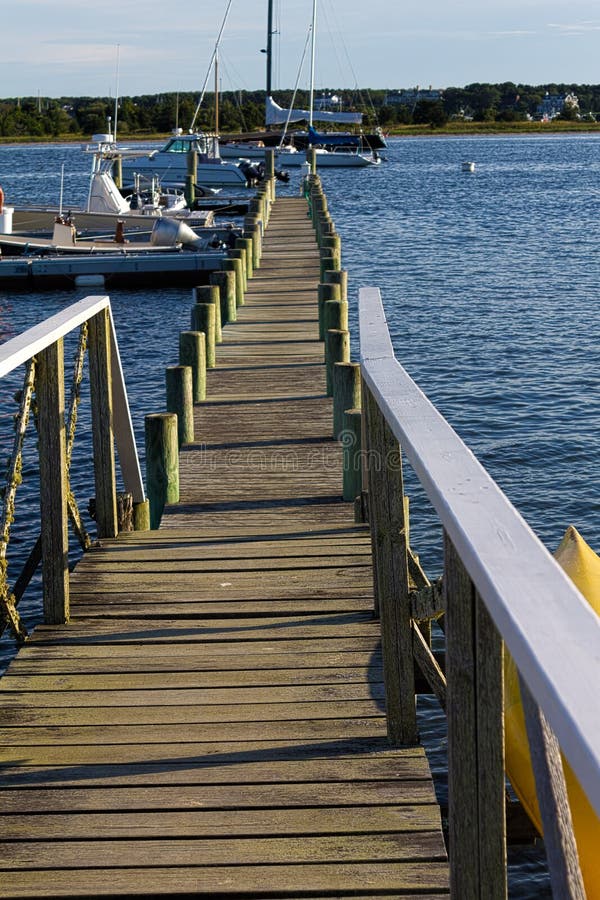 Long wooden pier in Edgartown Martha's Vineyard. Boardwalk rail stock images, royalty-free photos and pictures
