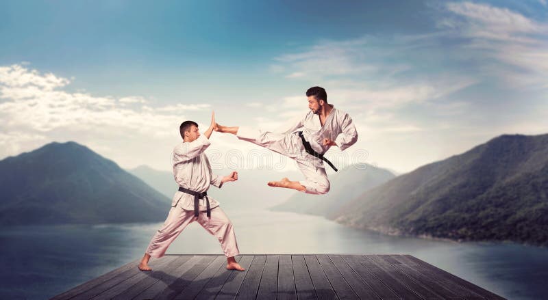 Martial arts, kick in jump, training on the pier stock photos Martial arts, kick in jump, training on the pier stock photos