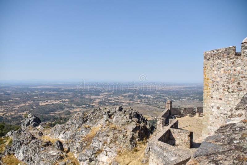 MarvÃ£o  is a municipality in Portalegre District in Portugal. The population in 2020 was 2,972 and dropping at a rate of around one inhabitant per week, in an area of 154.90 km2. The present Mayor is LuÃ­s Vitorino, elected by the Social Democratic Party. The municipal holiday is September 8.

Perched on a quartzite crag of the Serra de SÃ£o Mamede, MarvÃ£o`s name is derived from an 8th-century Muwallad rebel, named Ibn Marwan. Ibn Marwan, who constructed the Castle of MarvÃ£o - likely on the site of an earlier Roman watchtower - as a power base when establishing an independent statelet `emirate`, duchy - covering much of modern-day Portugal - during the Emirate of Cordoba 884-931 CE. The castle and walled village were further fortified through the centuries, notably under Sancho II of Portugal 13th century and Denis of Portugal.

The village has generated significant tourist interest in recent years. It was included in the #1 New York Times bestselling book, 1000 Places to see Before you Die.[3] Nobel Prize-winning author JosÃ© Saramago wrote of the village, `From MarvÃ£o one can see the entire land ... It is understandable that from this place, high up in the keep at MarvÃ£o Castle, visitors may respectfully murmur, `How great is the world`.`. MarvÃ£o  is a municipality in Portalegre District in Portugal. The population in 2020 was 2,972 and dropping at a rate of around one inhabitant per week, in an area of 154.90 km2. The present Mayor is LuÃ­s Vitorino, elected by the Social Democratic Party. The municipal holiday is September 8.

Perched on a quartzite crag of the Serra de SÃ£o Mamede, MarvÃ£o`s name is derived from an 8th-century Muwallad rebel, named Ibn Marwan. Ibn Marwan, who constructed the Castle of MarvÃ£o - likely on the site of an earlier Roman watchtower - as a power base when establishing an independent statelet `emirate`, duchy - covering much of modern-day Portugal - during the Emirate of Cordoba 884-931 CE. The castle and walled village were further fortified through the centuries, notably under Sancho II of Portugal 13th century and Denis of Portugal.

The village has generated significant tourist interest in recent years. It was included in the #1 New York Times bestselling book, 1000 Places to see Before you Die.[3] Nobel Prize-winning author JosÃ© Saramago wrote of the village, `From MarvÃ£o one can see the entire land ... It is understandable that from this place, high up in the keep at MarvÃ£o Castle, visitors may respectfully murmur, `How great is the world`.`