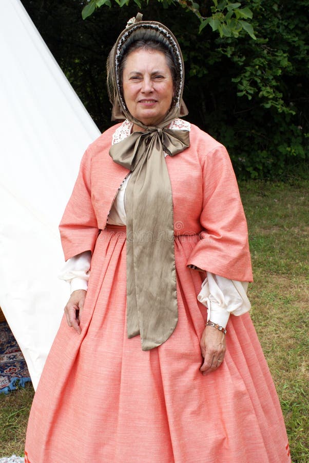 A lady re-enactor playing the part of Mary Lincoln standing by her tent at a Civil War re-enactment in the Willamette Valley of Oregon on the Fourth Of July.