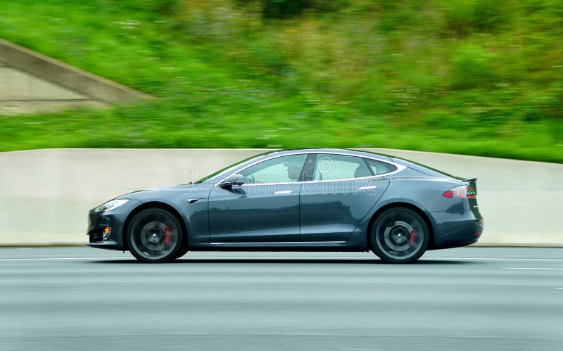 Maryland, U.S - August 16, 2020 - A grey color of Tesla Model S sedan all-electric car speeding on the road