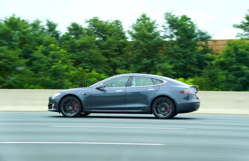 Maryland, U.S - August 16, 2020 - A grey color of Tesla Model S sedan all-electric car speeding on the road